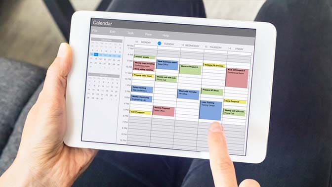 photo of a tablet with a calendar screen
